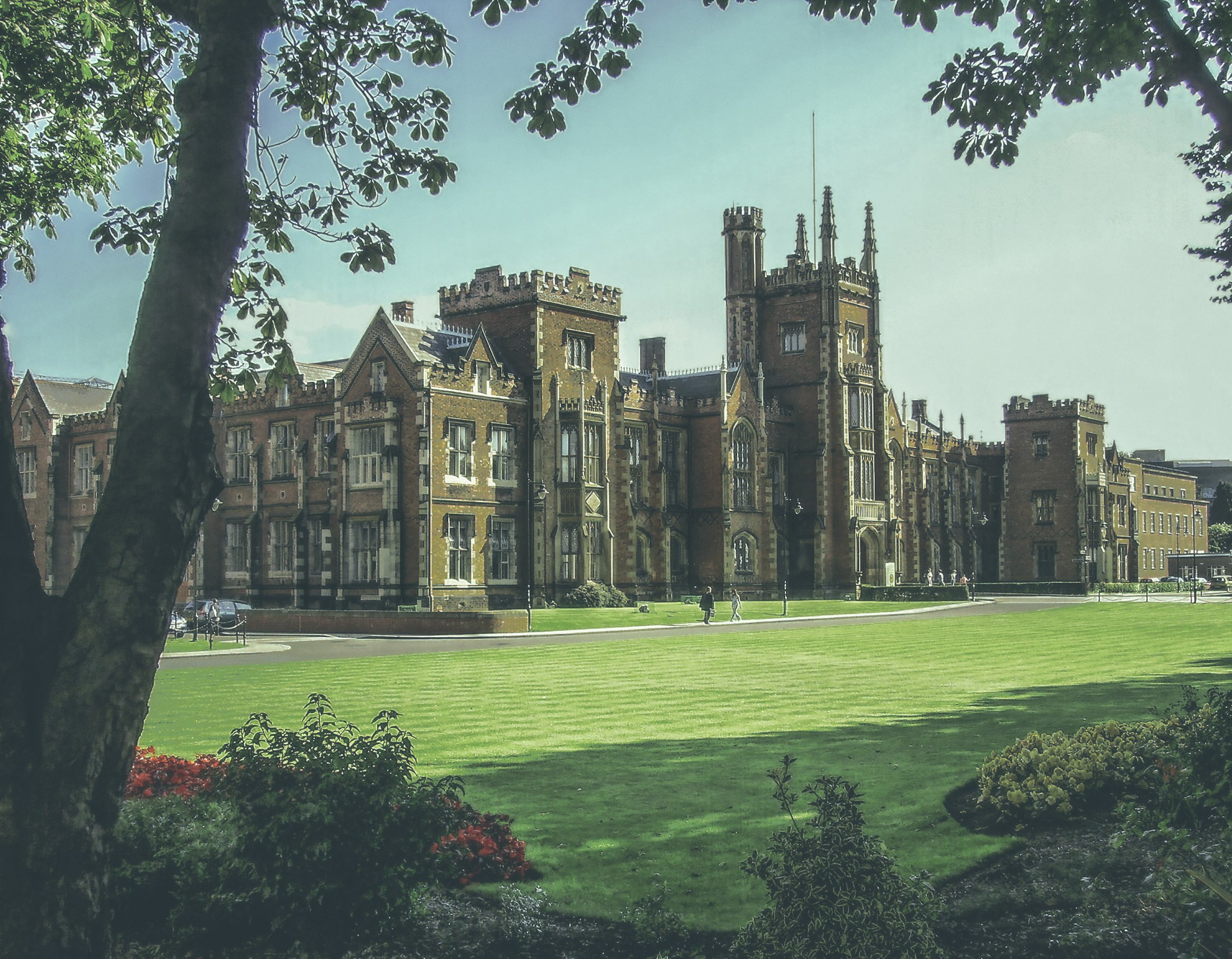 Students on the lawn in front of a historic university campus